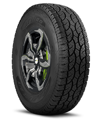 A car tire with a silver alloy wheel and green brake caliper, mounted on a black tire with detailed tread pattern.