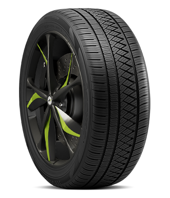 A car tire mounted on a rim with black and green spokes.