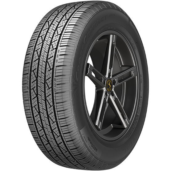 A car tire mounted on a black alloy wheel with a yellow logo at the center, showcasing detailed tread pattern and sidewall branding.