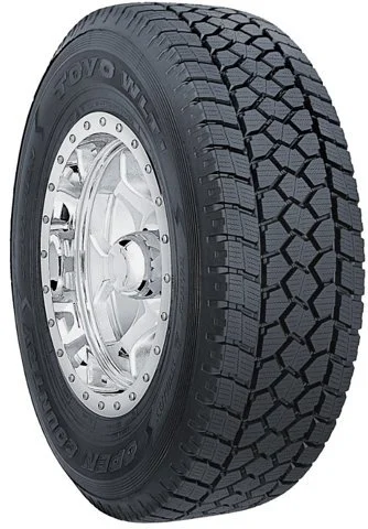 Close-up of a Black Lion brand all-terrain tire mounted on a shiny silver wheel, showing tread pattern and branding.