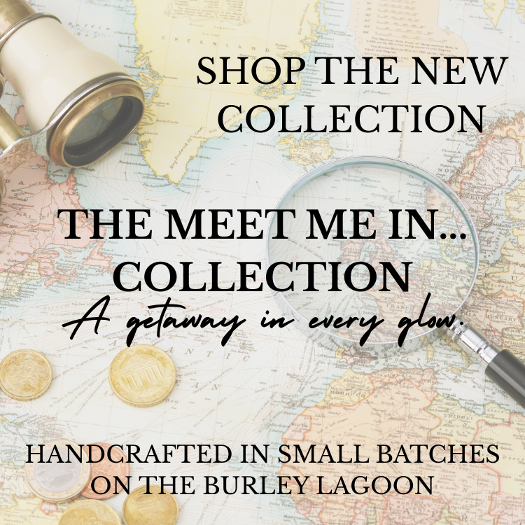 A promotional image for a new collection with travel-themed items including a vintage camera, a magnifying glass, and coins on a world map background, with text promoting the collection as handcrafted on Burley Lagoon.