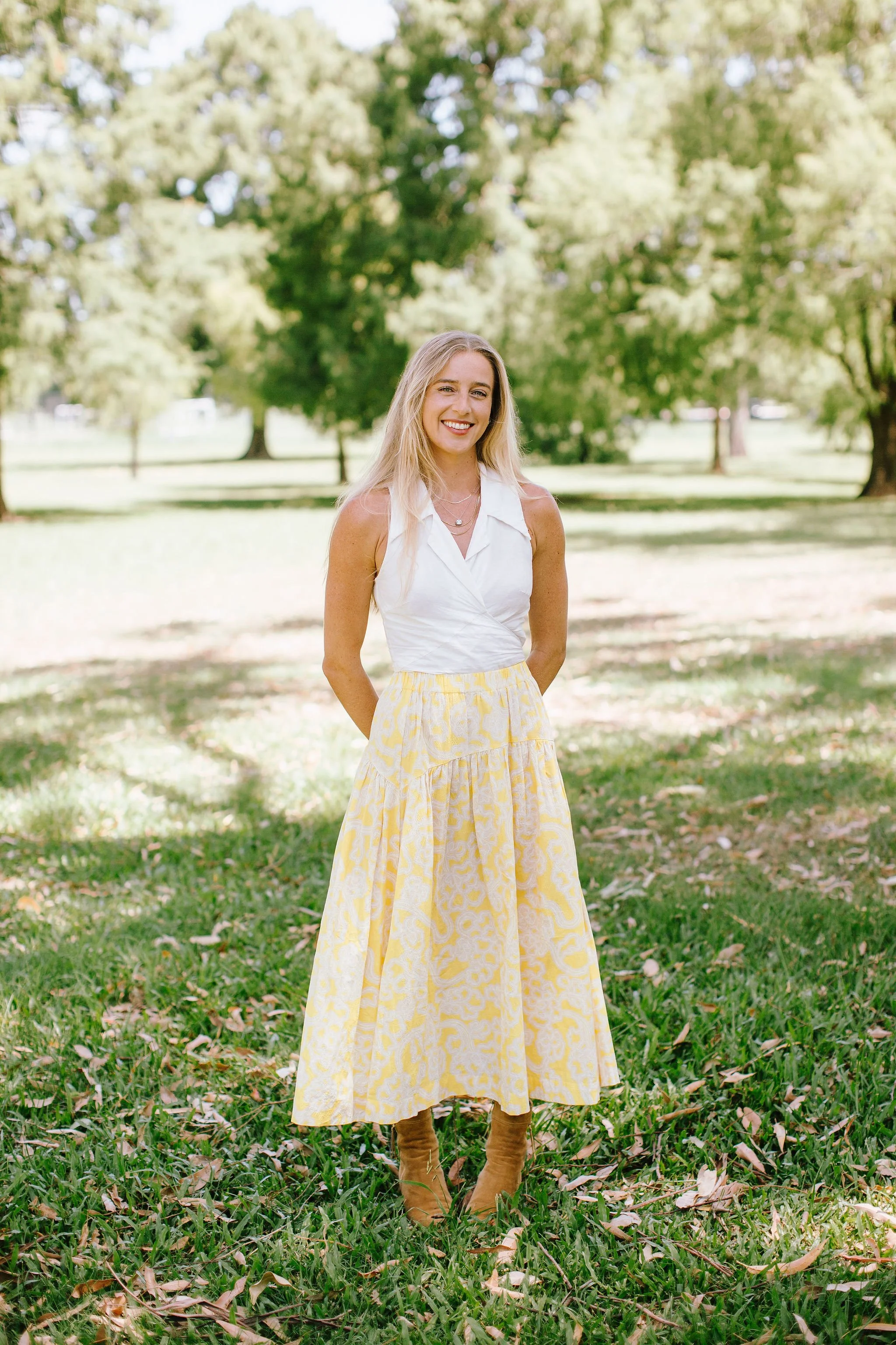 From above hands of unrecognizable woman rubbing aromatic spices into piece of raw meat over parchment paper