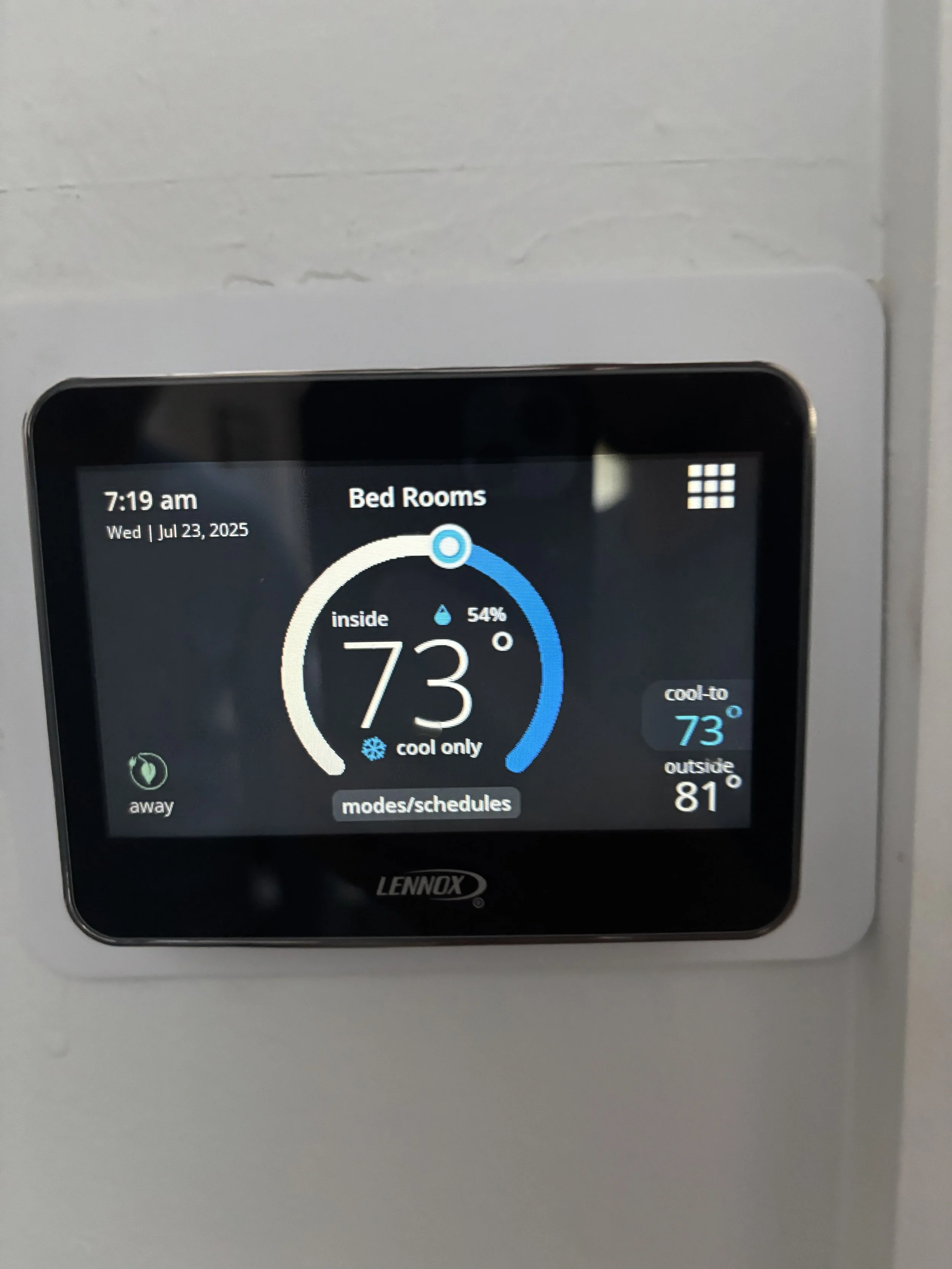 Thermostat screen displaying indoor temperature of 73°F, outside temperature of 81°F, humidity at 54%, and the time as 7:19 am on July 23, 2025.