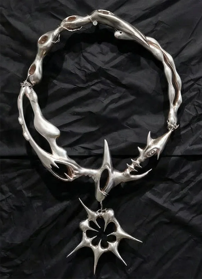 Gera, "Support Structure: Dog Collar" 2024.
Lost-wax cast titanium, silver-plated. 13 x 8 inches. Contact: reborntomakeyouhappy@gmail.com