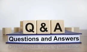 Wooden blocks displaying Q and A symbols, with a sign reading 'Questions and Answers' underneath.