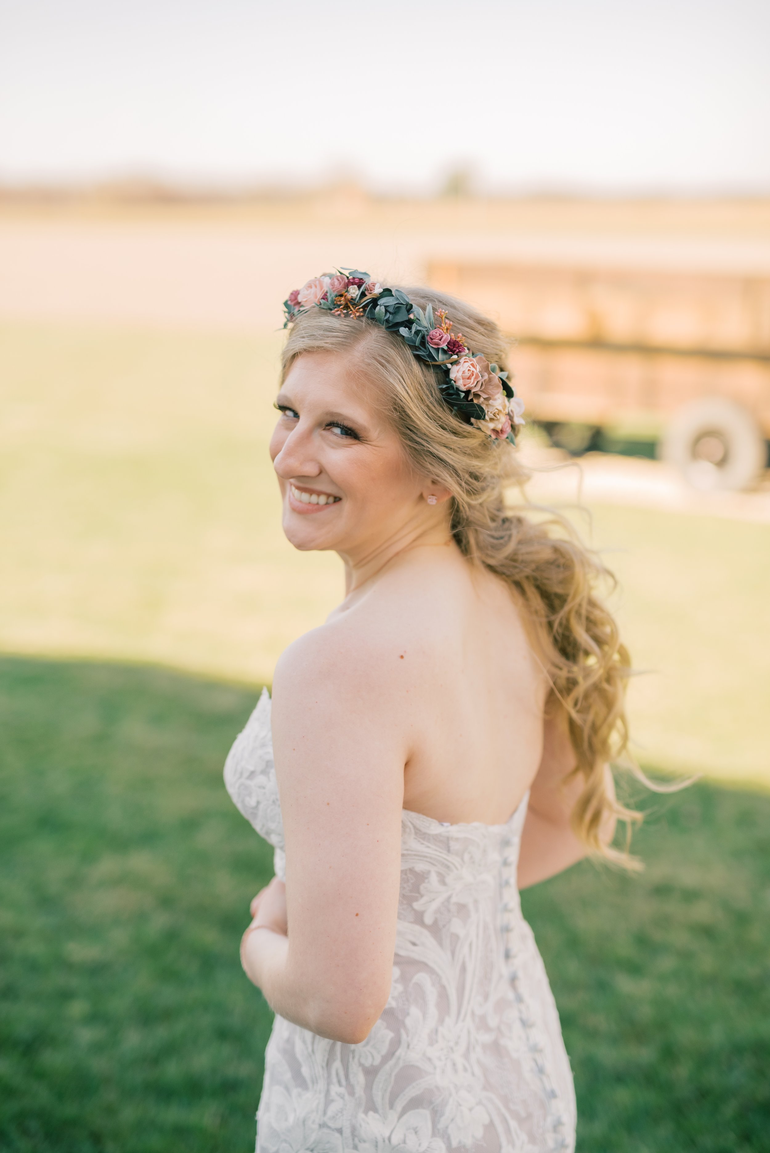 A bride with blonde hair styled in a long whimsical braid