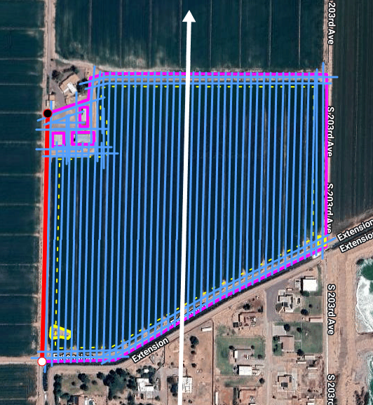 Aerial view of a solar farm, outlined with colored overlays and a white arrow pointing north, near residential area and water body.