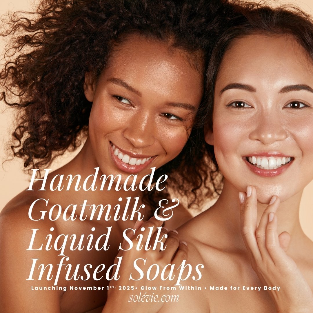 Two smiling women with radiant skin posing together, promoting handmade goat milk and liquid silk infused soaps for a beauty product launch.