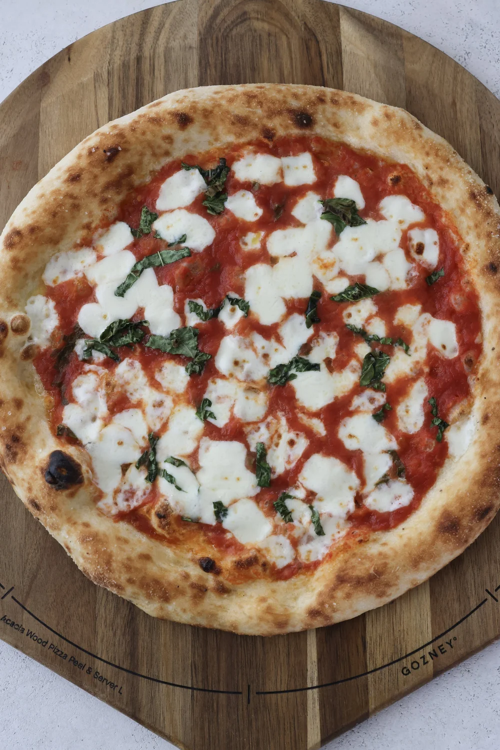 Margherita pizza fresh from the live-fire oven