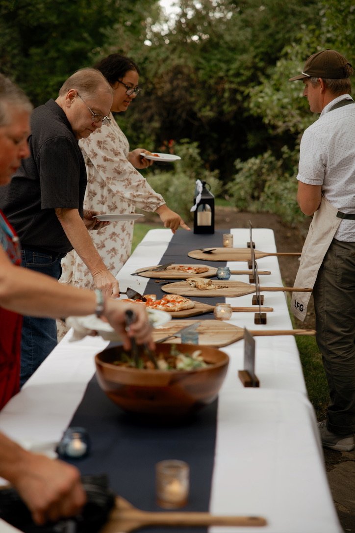 Guests gathered around the pizza table