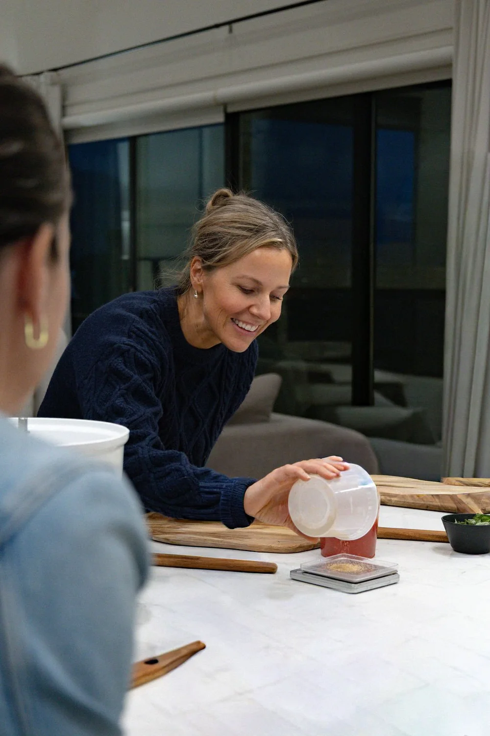 Guest stretching dough during a pizza class