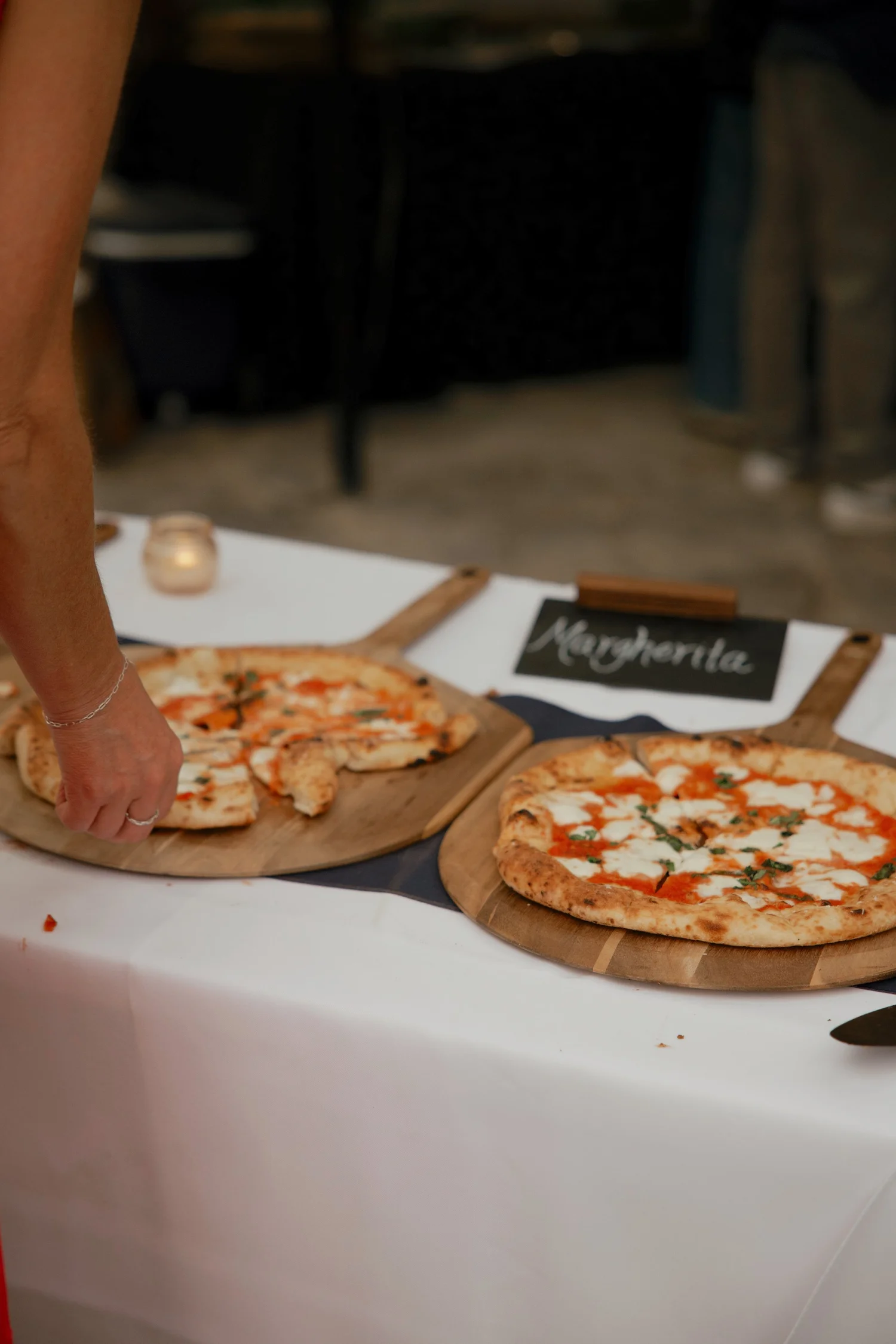 Margherita pizzas on wooden boards at a Thirteen's Pizza event