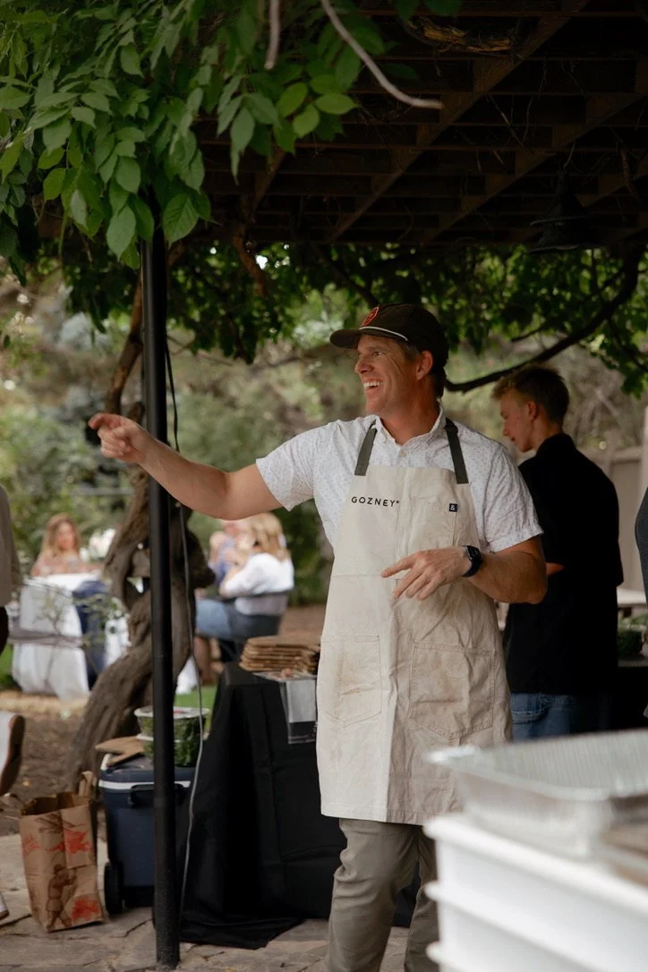 Chef serving guests at an outdoor event