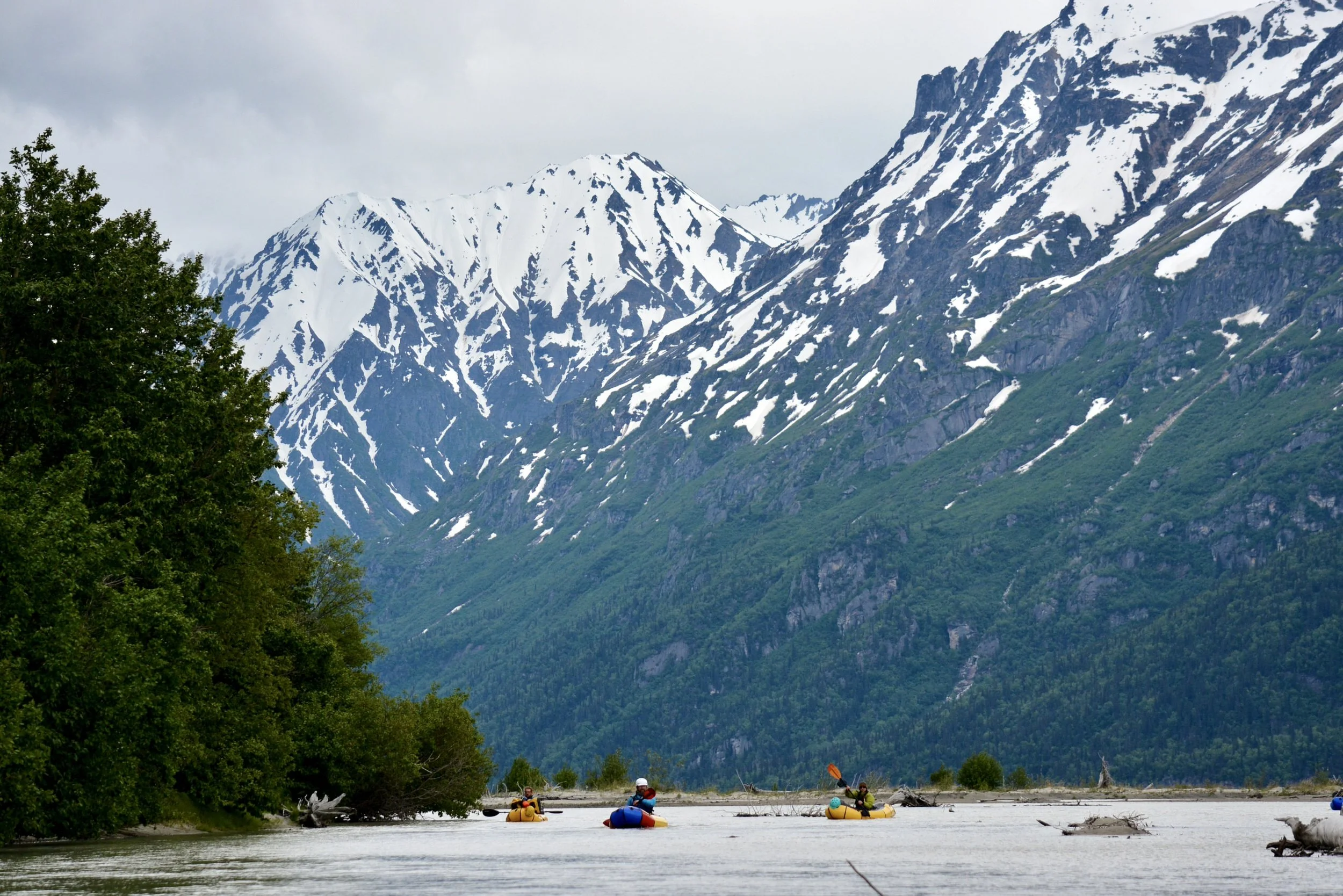 Packrafters paddling to water taxi after floating the Tlikakila River in Lake Clark National Park