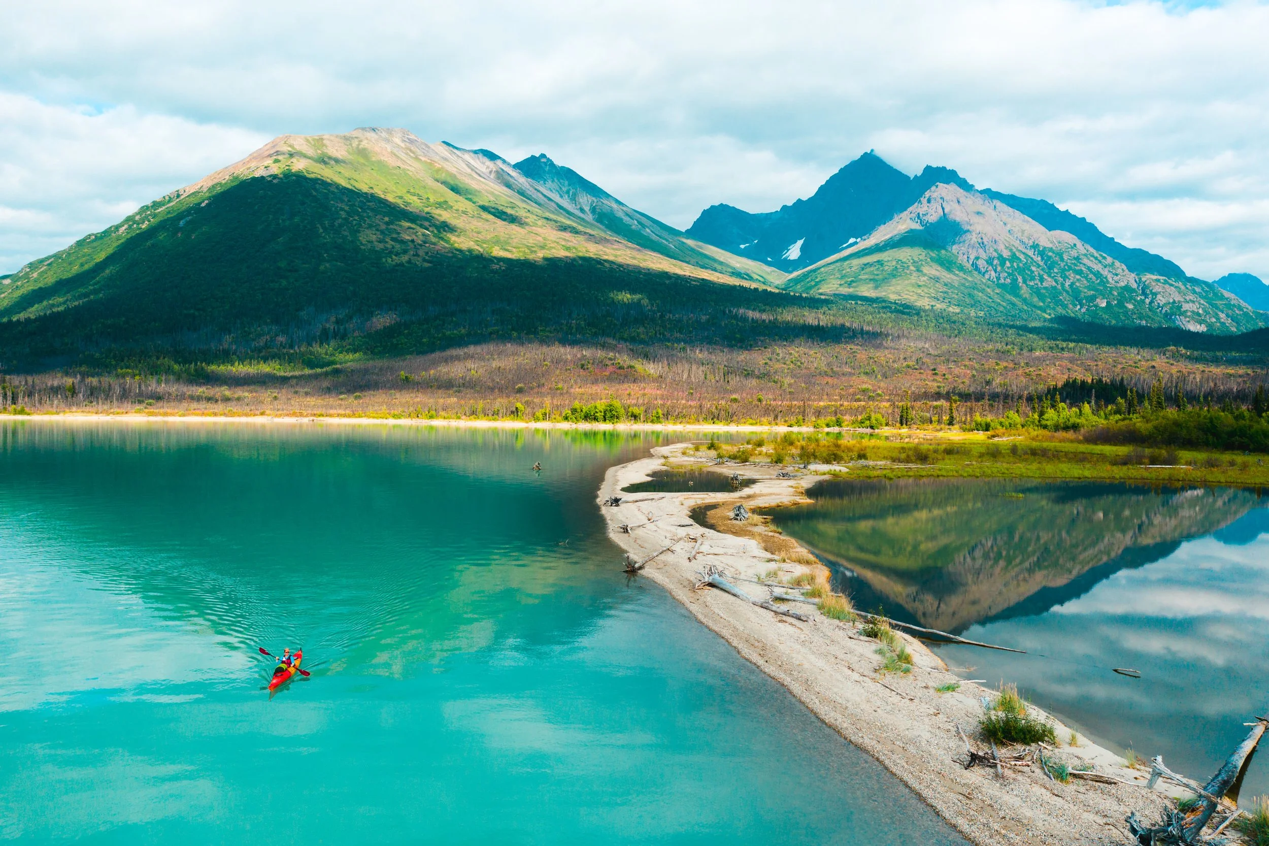 Kayaker paddling Lake Clark's turquoise waters