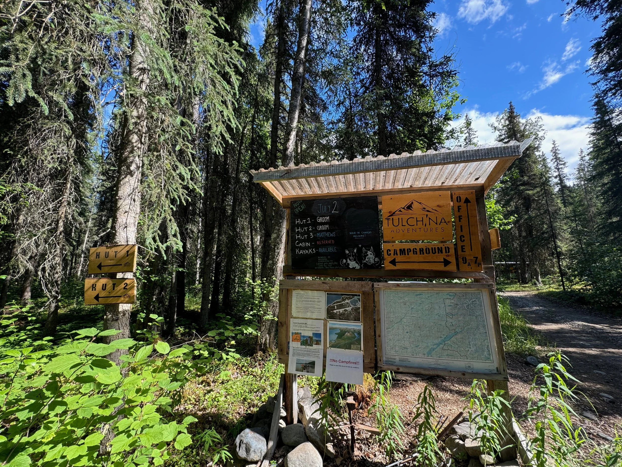 Sign at trailhead to Port Aslworth campground. Chalkboard sign updated daily with hut assignments and updates.