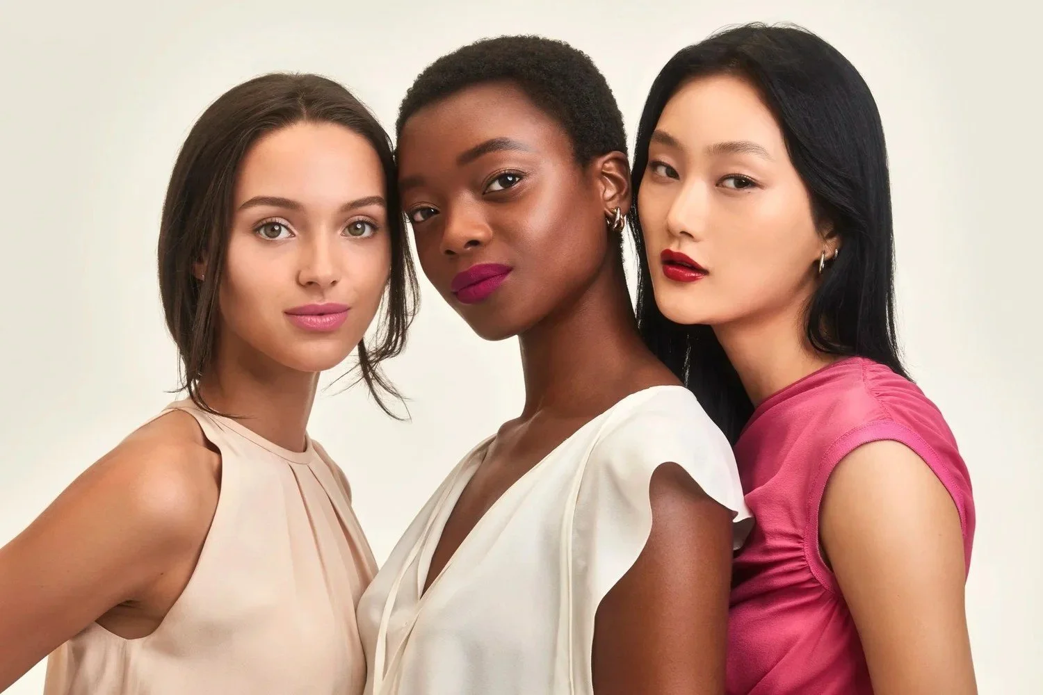Campaign key visual, three models in white and pink wearing Elizabeth Arden Ceramide lipstick shades
