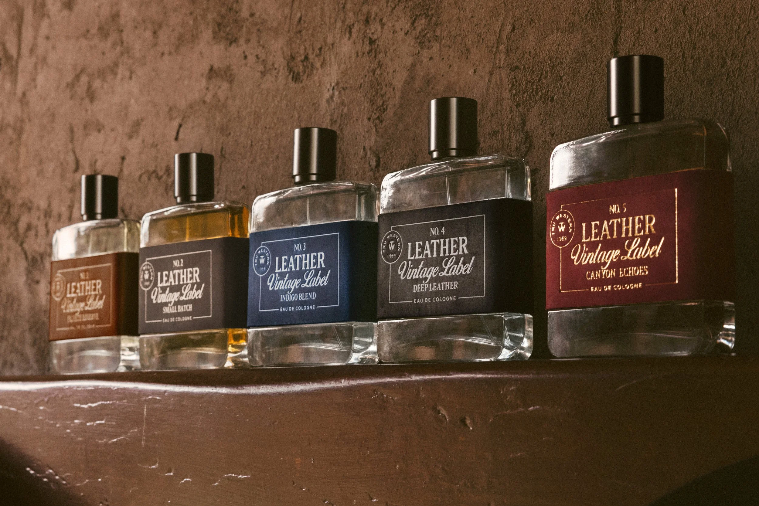 The Leather Vintage Label collection lined up on an adobe ledge, No. 1 to No. 5, ending on Canyon Echoes in red suede.