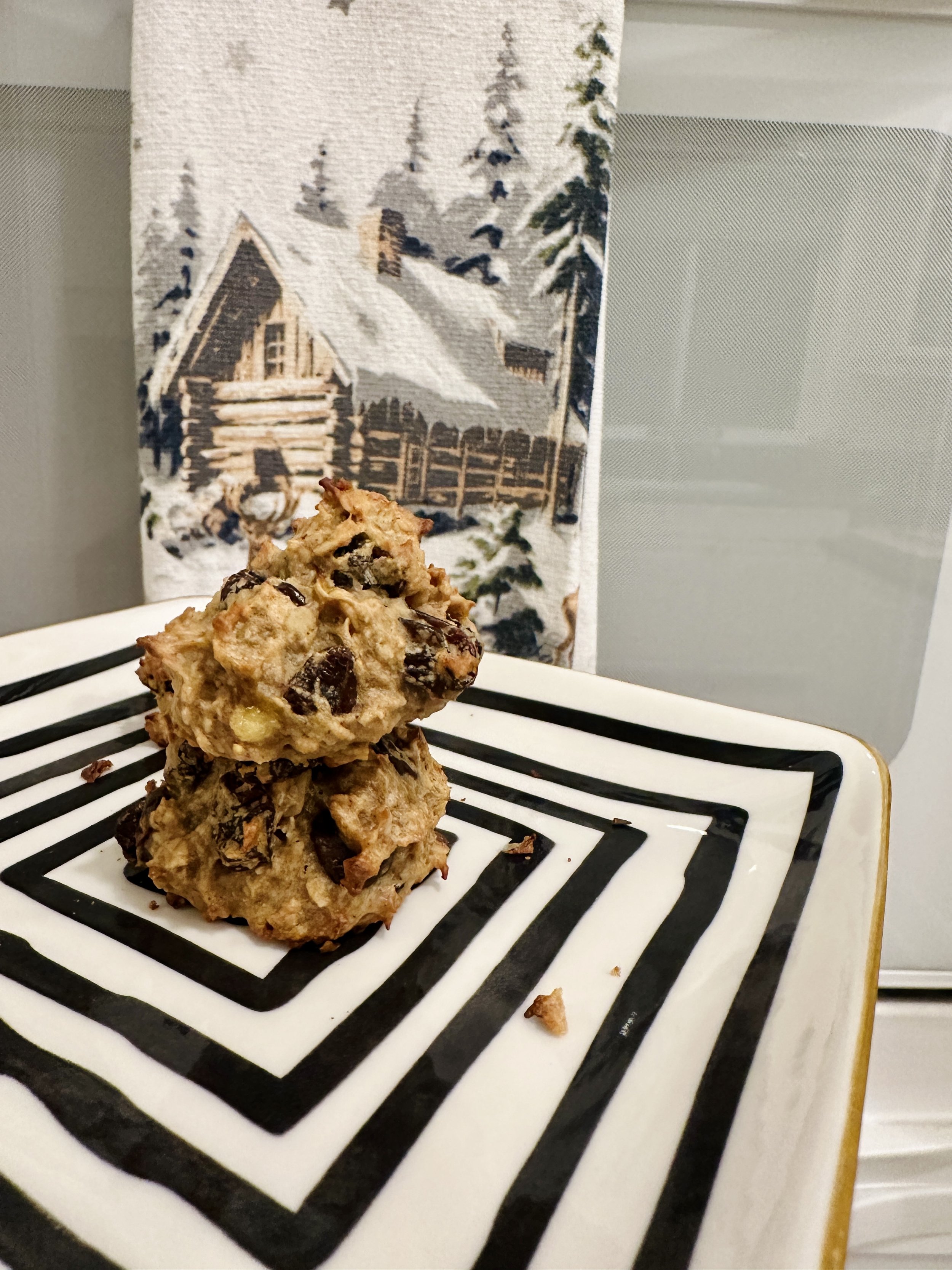 Baked oatmeal cookies with raisins cooling on a plate