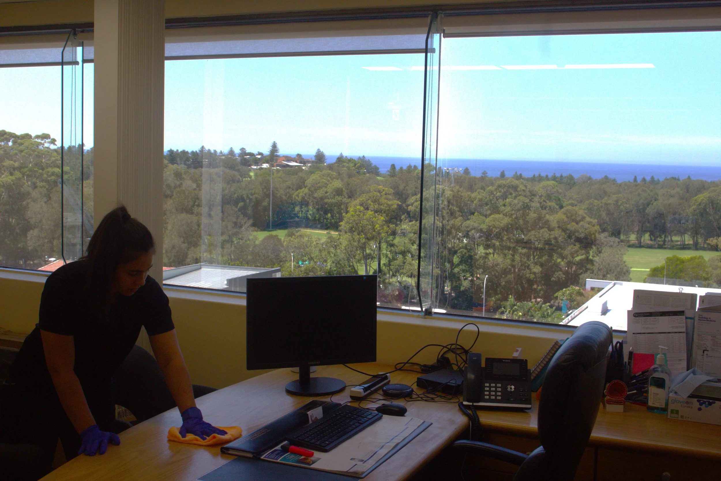 lady vacuuming carpet in office building