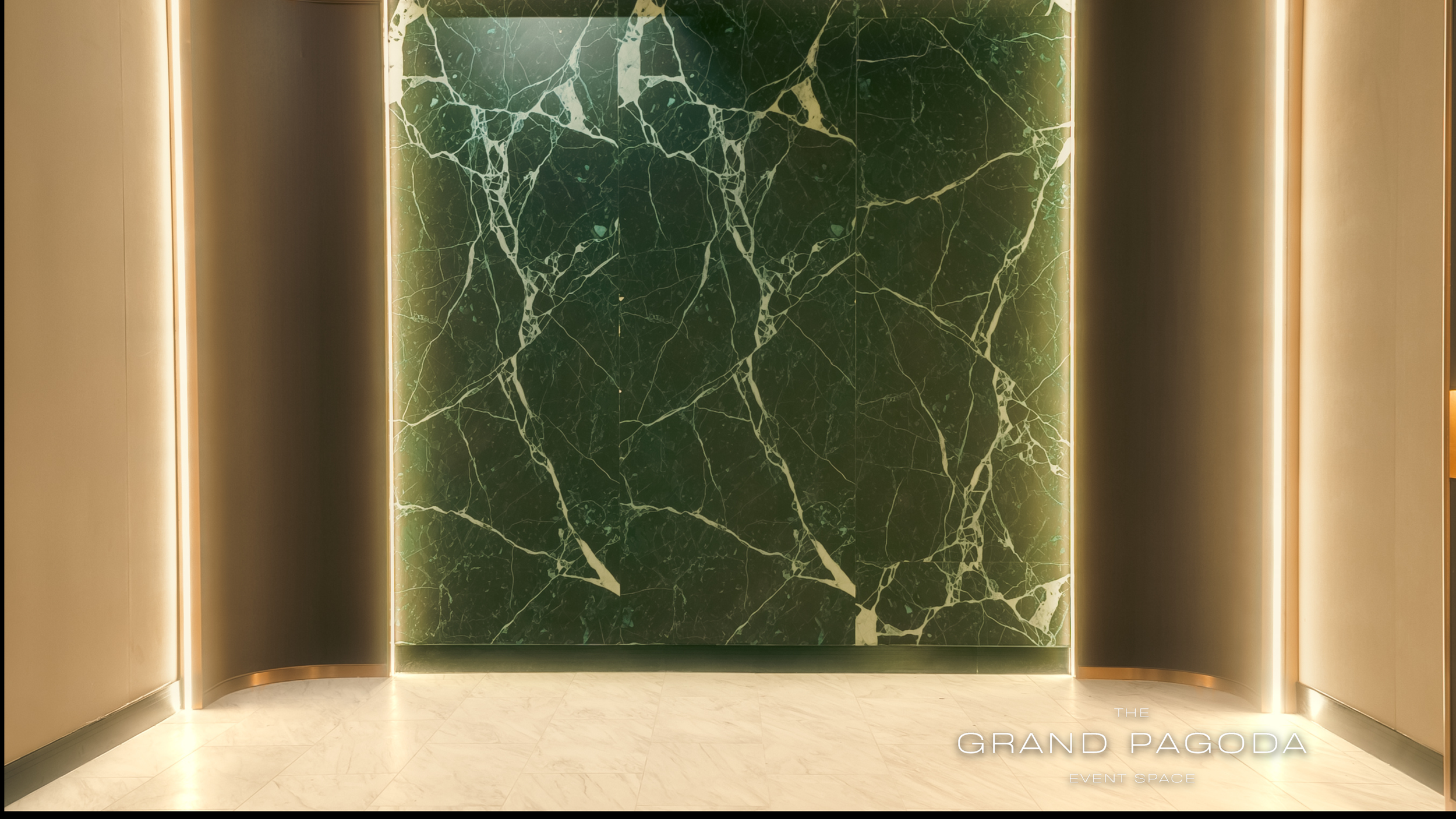 An elegant event space with a dark green marble wall featuring white veining, flanked by warm golden walls with vertical lighting strips, and a smooth marble floor. The words "THE GRAND PAGODA EVENT SPACE" are visible at the bottom right corner.