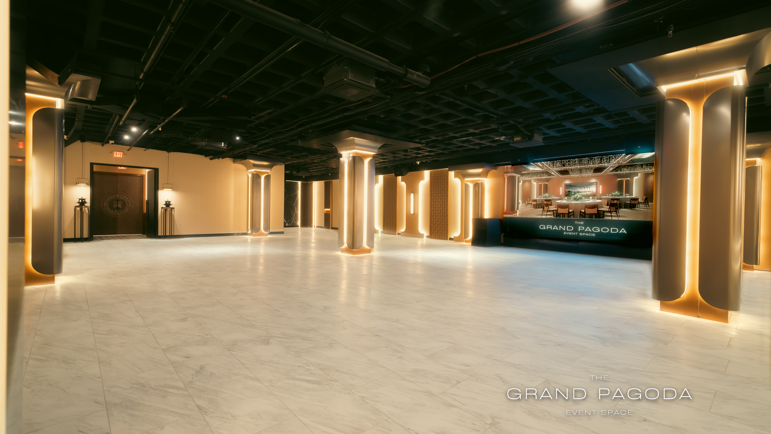 Interior of a modern event space named The Grand Pagoda, with decorative lighting, pillars, and a reception desk.