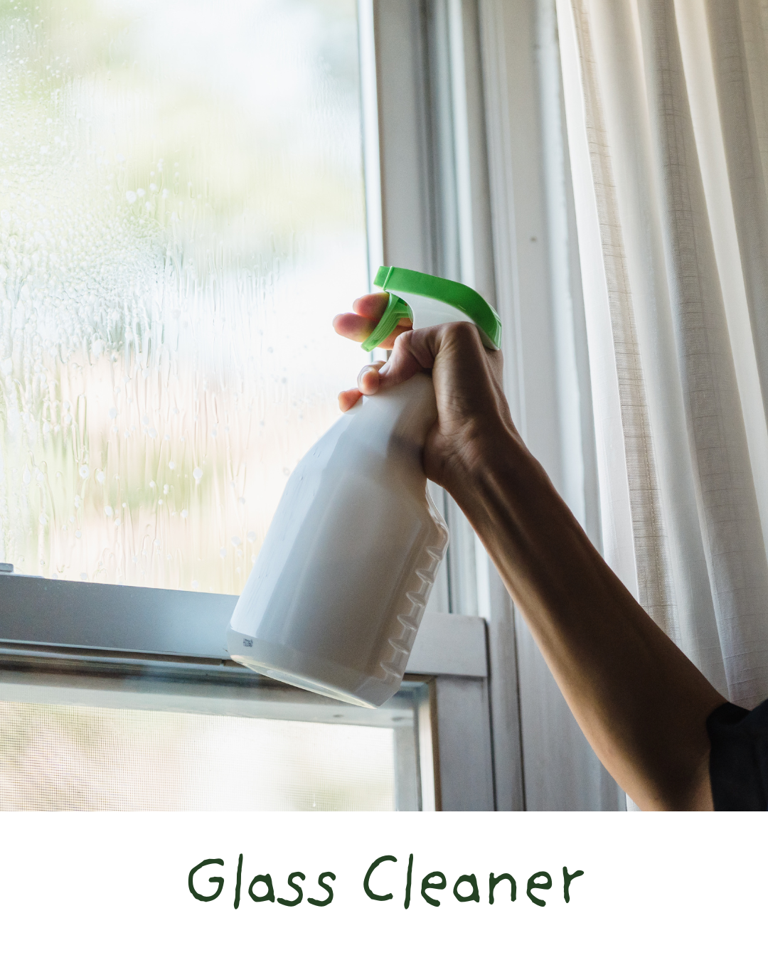 Person cleaning a window with a spray bottle of glass cleaner.