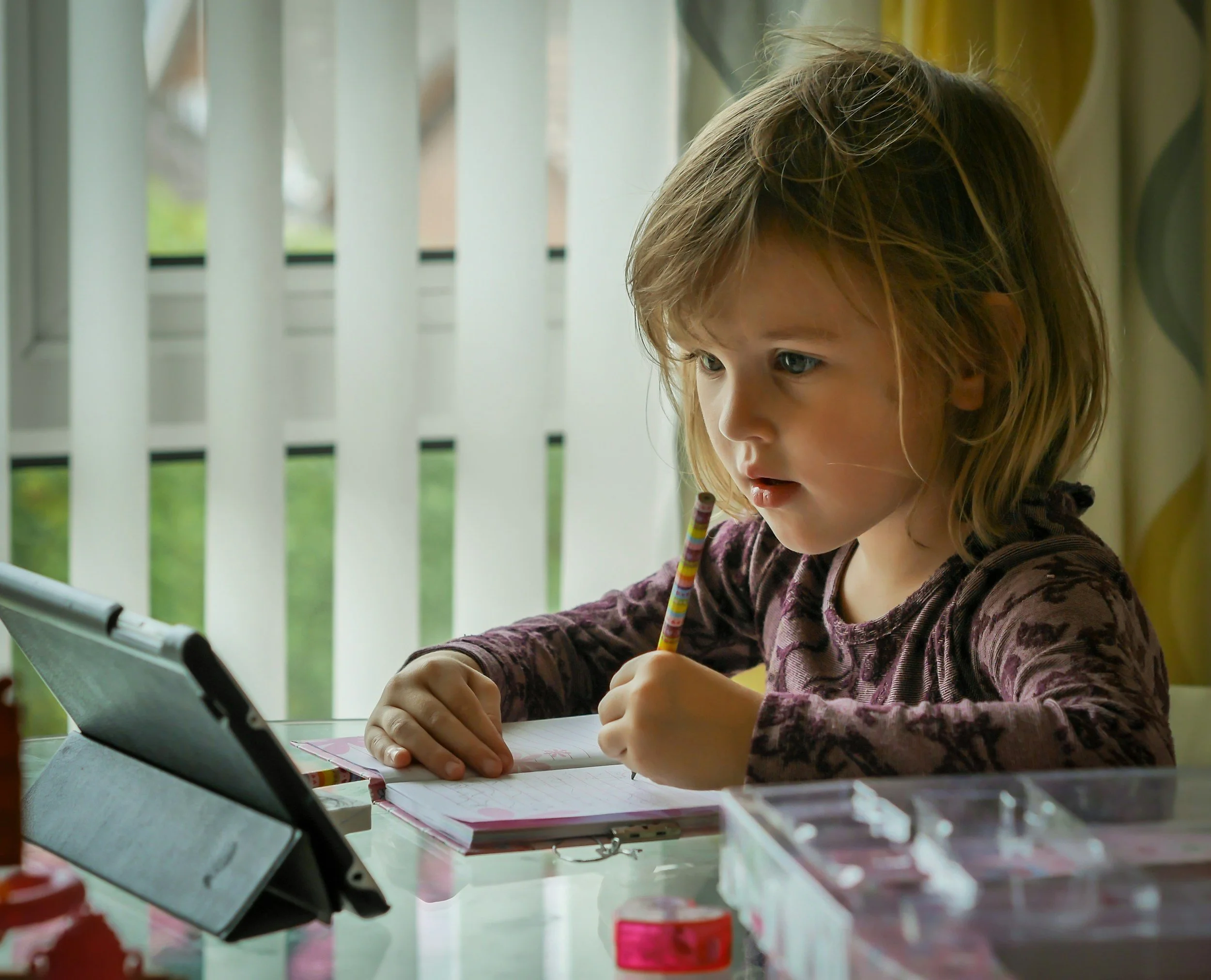 Child drawing during an online child counselling and art therapy session at home