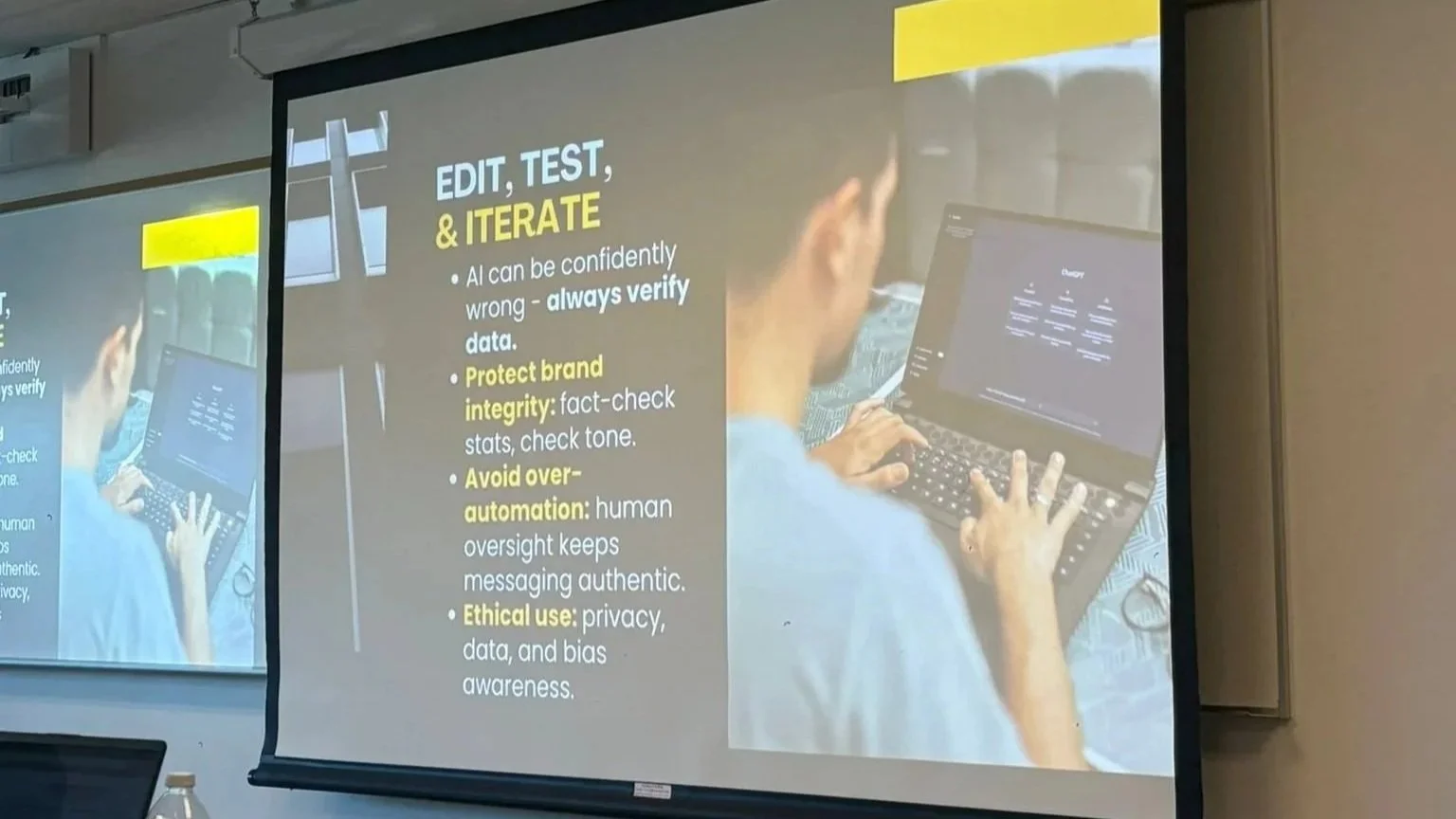 A presentation slide with the title "EDIT, TEST, & ITERATE." The slide contains bullet points about AI, brand integrity, preventing over-automation, and ethical use, with a background image of a person using a laptop.
