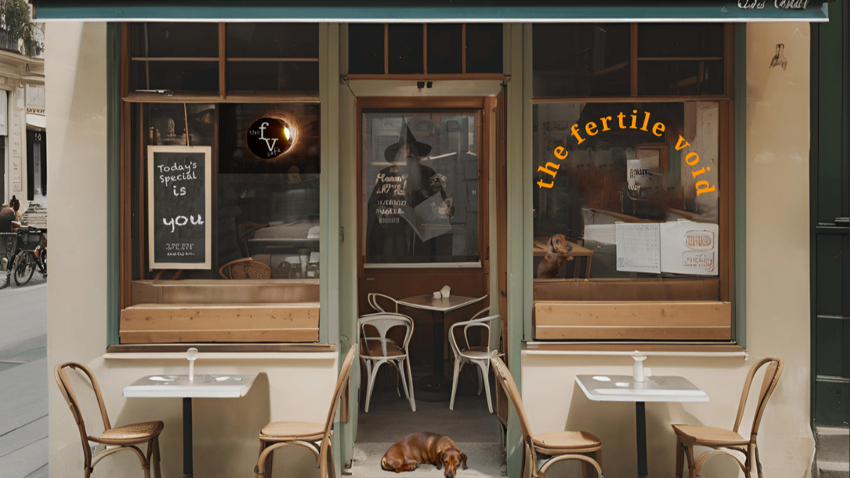 Front of a small cafe with outdoor seating, two small tables with chairs, and a dog lying on the sidewalk. The cafe has window signs and a door with a reflection of a woman. Text on the window reads 'the fertile void' and a chalkboard sign says 'Today's Special is You'.