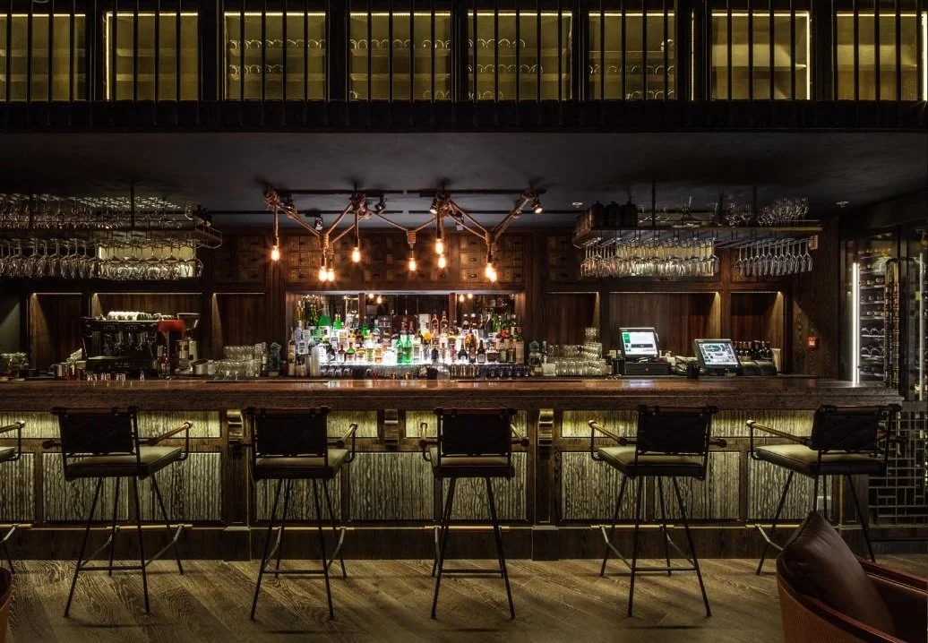 Mott 32, an award-winning Chinese Restaurant, interior bar counter by Wang Fang Construction. A mix of modern and rustic decor in Hong Kong Central