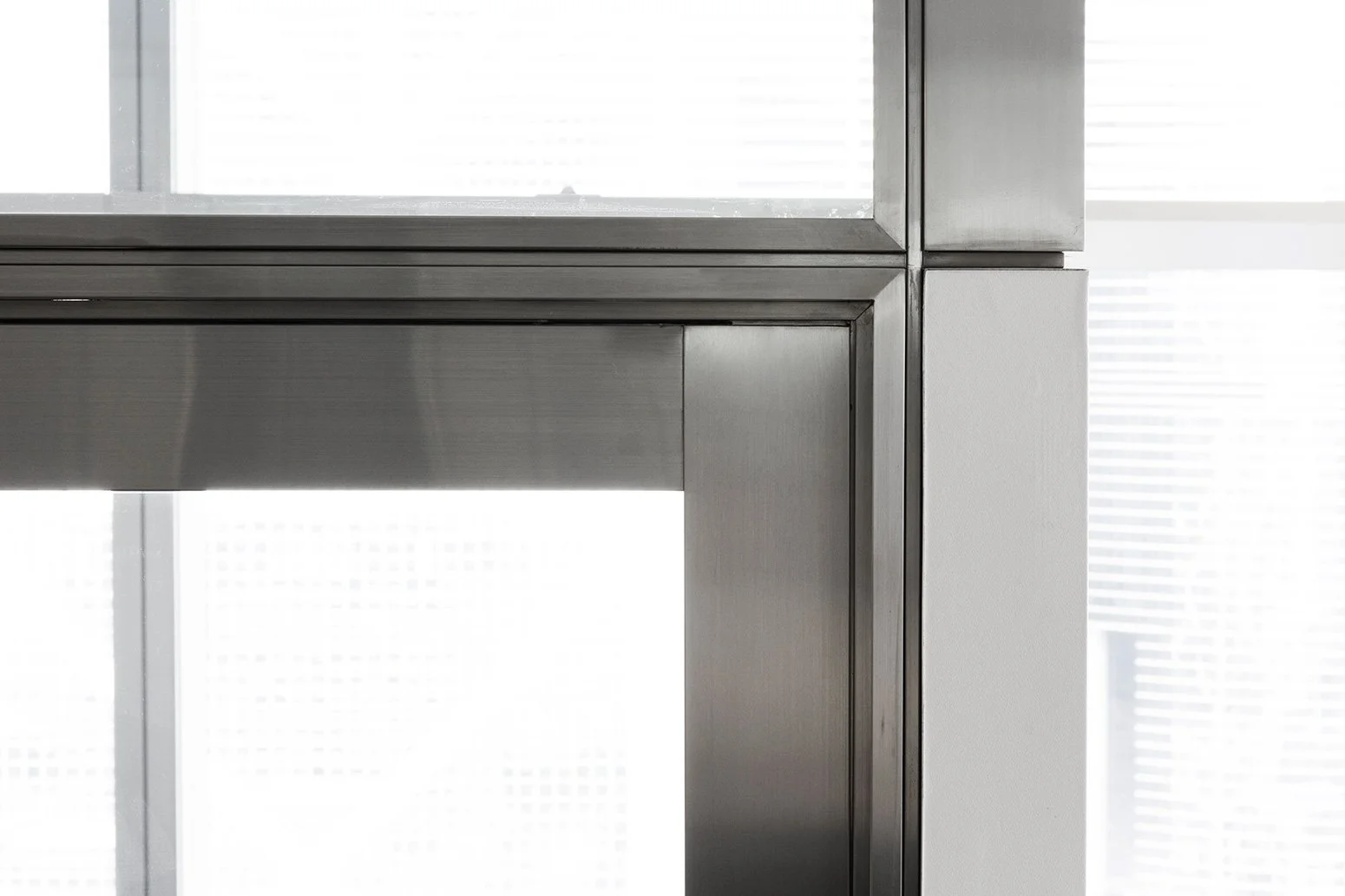 BBO office by Wan Fang Construction showing close-up of a modern, metallic window frame, showcasing sleek design and clean lines; minimal ambiance in Hong Kong Central.