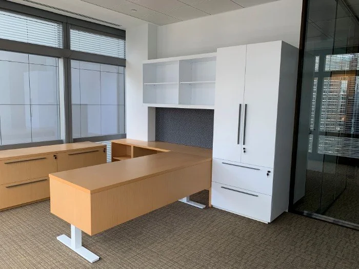 Debevoise & Pimpton office by Wan Fang Construction showing a modern workspace with glass walls, wooden desks, and abundant natural light in Hong Kong Central.