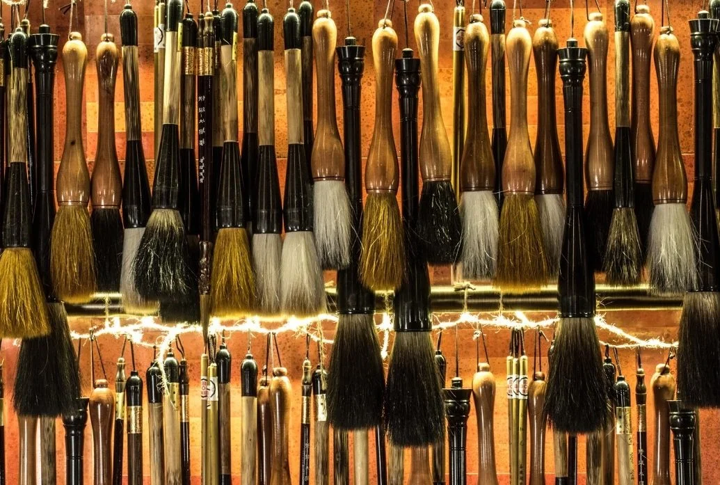 Mott 32, an award-winning Chinese Restaurant, interior dining area by Wang Fang Construction, featuring its walls are adorned with Chinese brush art, in Hong Kong Central. 