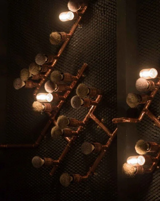 Rhoda modern restaurant by Wan Fang Construction, showing modern rustic copper light fixtures for warm, dim lighting ambiance in Hong Kong, Sai Yin Pun.