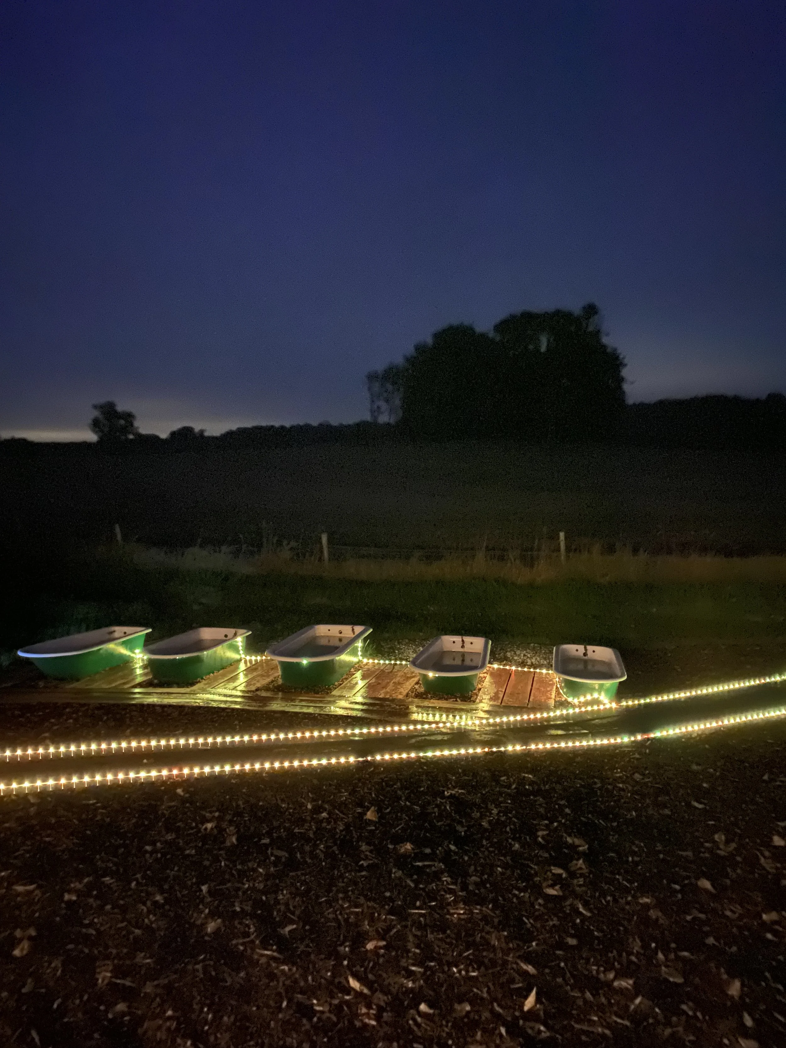 Night time rustic outdoor Sauna and natural water plunge pools at Hot rocks sauna Grangecon