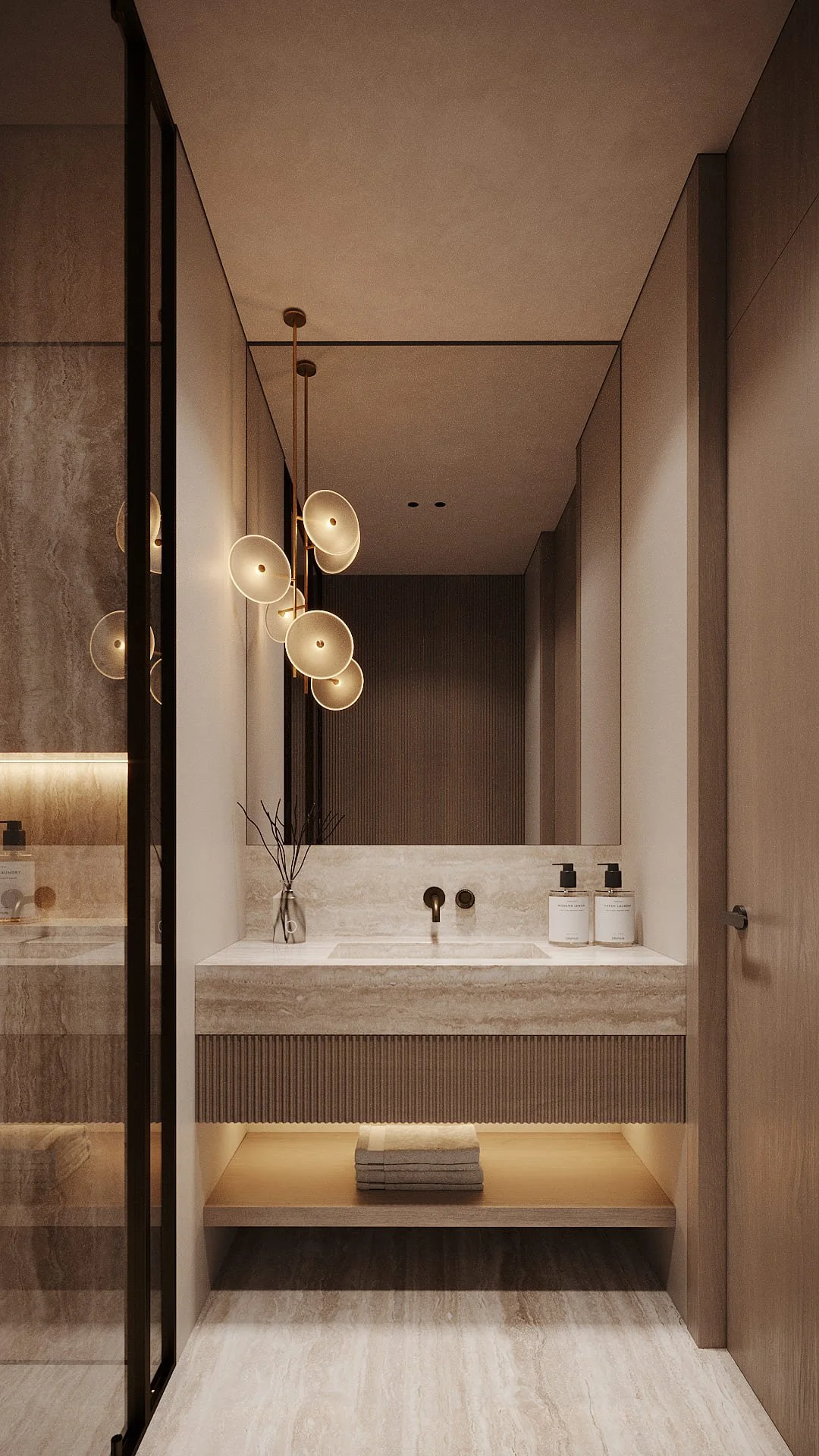 Bathroom vanity in Villa De Bomma, Jumeirah Islands, with a travertine countertop, ribbed cabinet, and sculptural disc pendant lights by Limestone