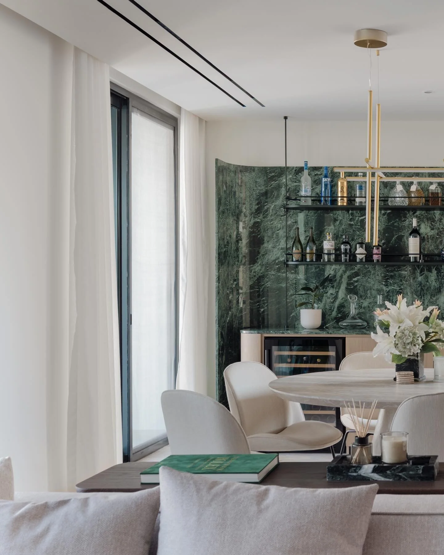 The full picture 📸

Here is how the interplay of natural stone and timber comes together in the main living space. We created this bespoke bar to frame the dining area, adding a layer of sophisticated color and texture to the neutral palette.

Every