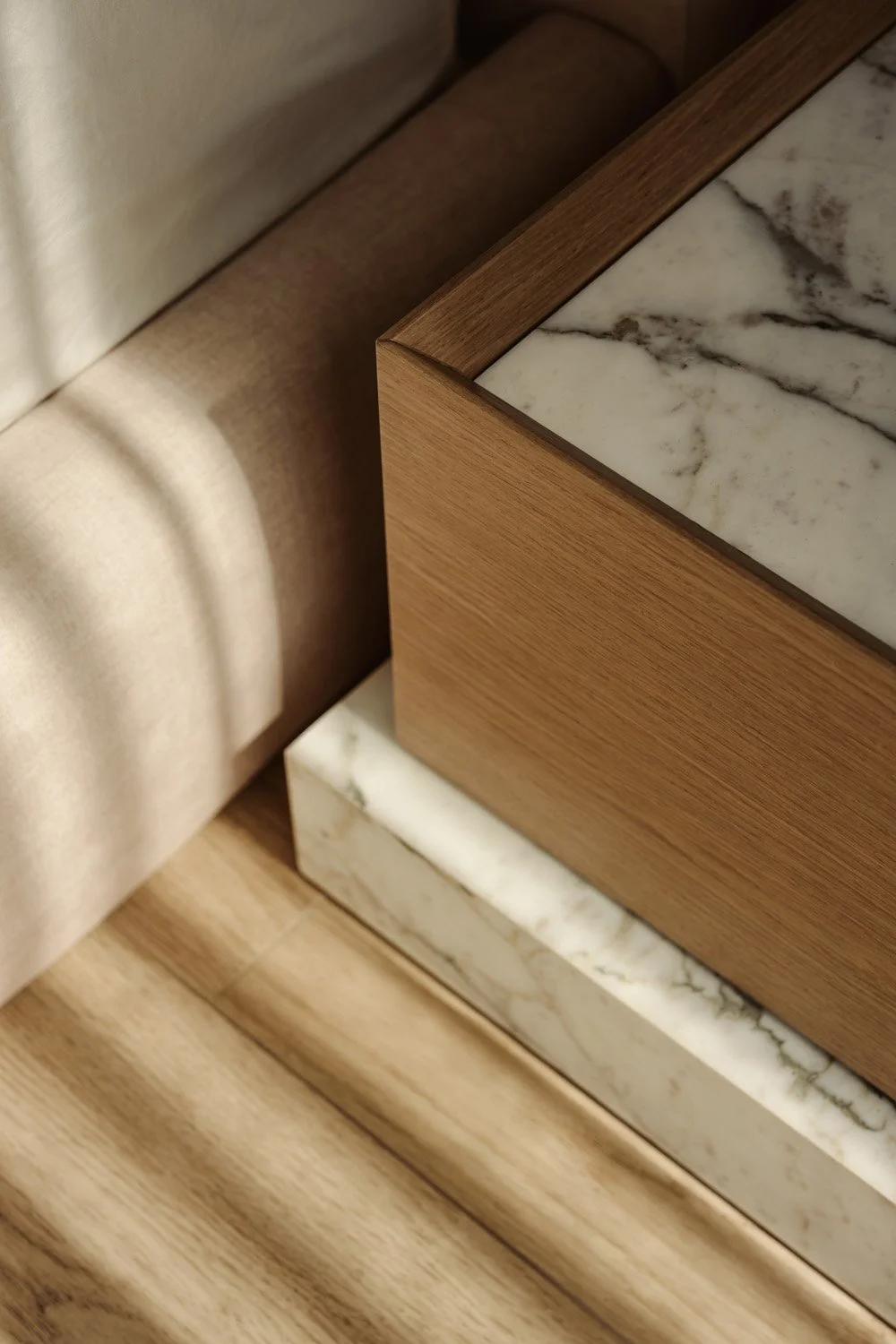 Close-up detail of a bespoke bedroom nightstand with a hand-finished oak body, Calacatta marble top, and brushed brass base detail, designed by Limestone for a luxury villa in Dubai
