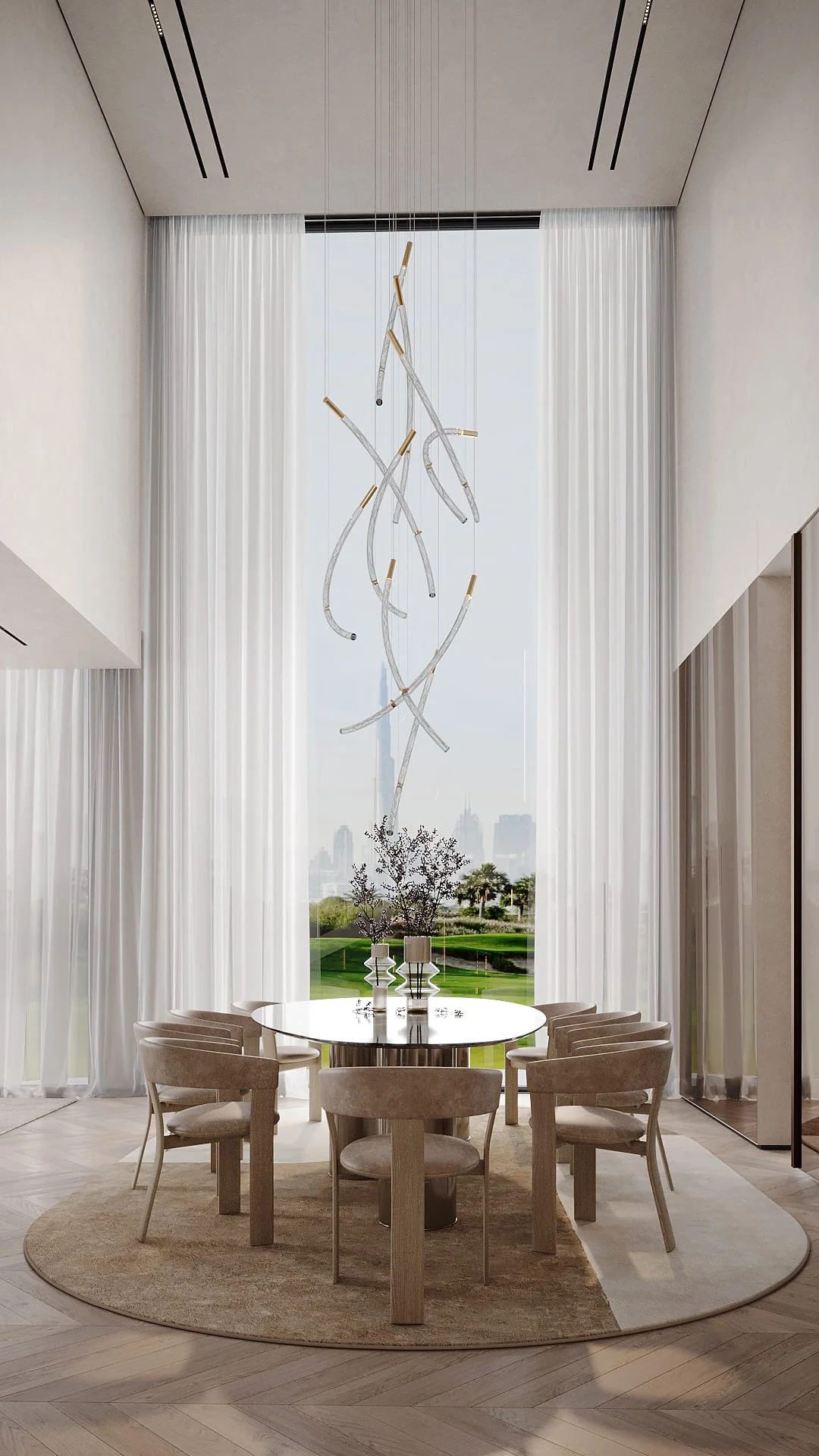Dining room in Villa De Bomma, Jumeirah Islands, with a double-height sculptural glass and brass chandelier, round dining table, and floor-to-ceiling golf course views by Limestone