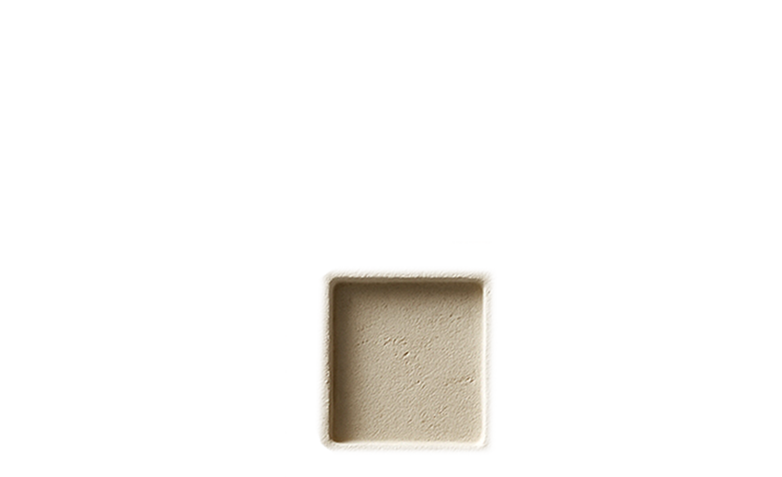 Close-up of an empty, square, beige-colored box with a rough, textured surface.