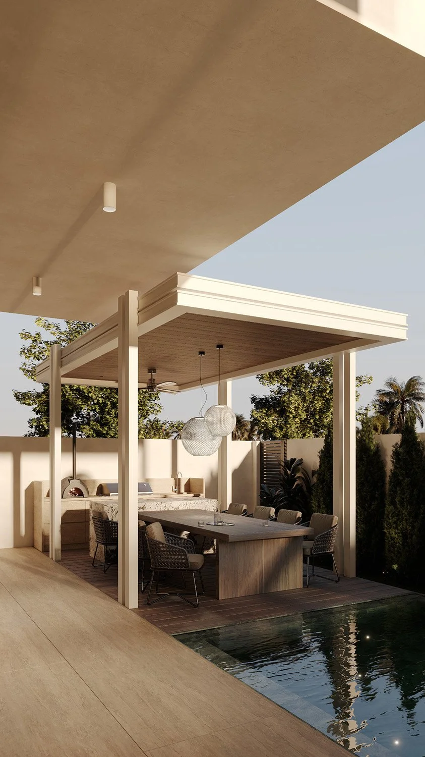 Outdoor kitchen and dining pavilion in a Dubai Hills villa landscape, with a pizza oven, BBQ station, dining table, and views over the Sukabumi tile pool, designed by Limestone