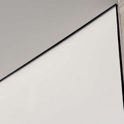Limestone signature detail — 15mm shadow gap painted black and terminated with matching door architrave, creating a floating ceiling effect and adding visual height, luxury interior design Dubai