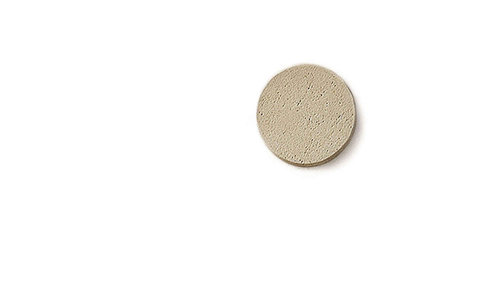 A beige circular medical pill with a smooth surface.
