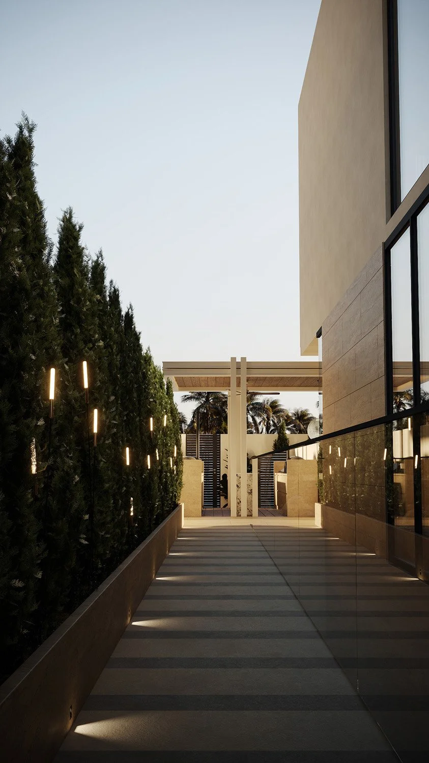 Side garden pathway in a Dubai Hills villa landscape, lined with Ficus panda trees shaped as a privacy hedge, travertine paving, and uplighting, designed by Limestone