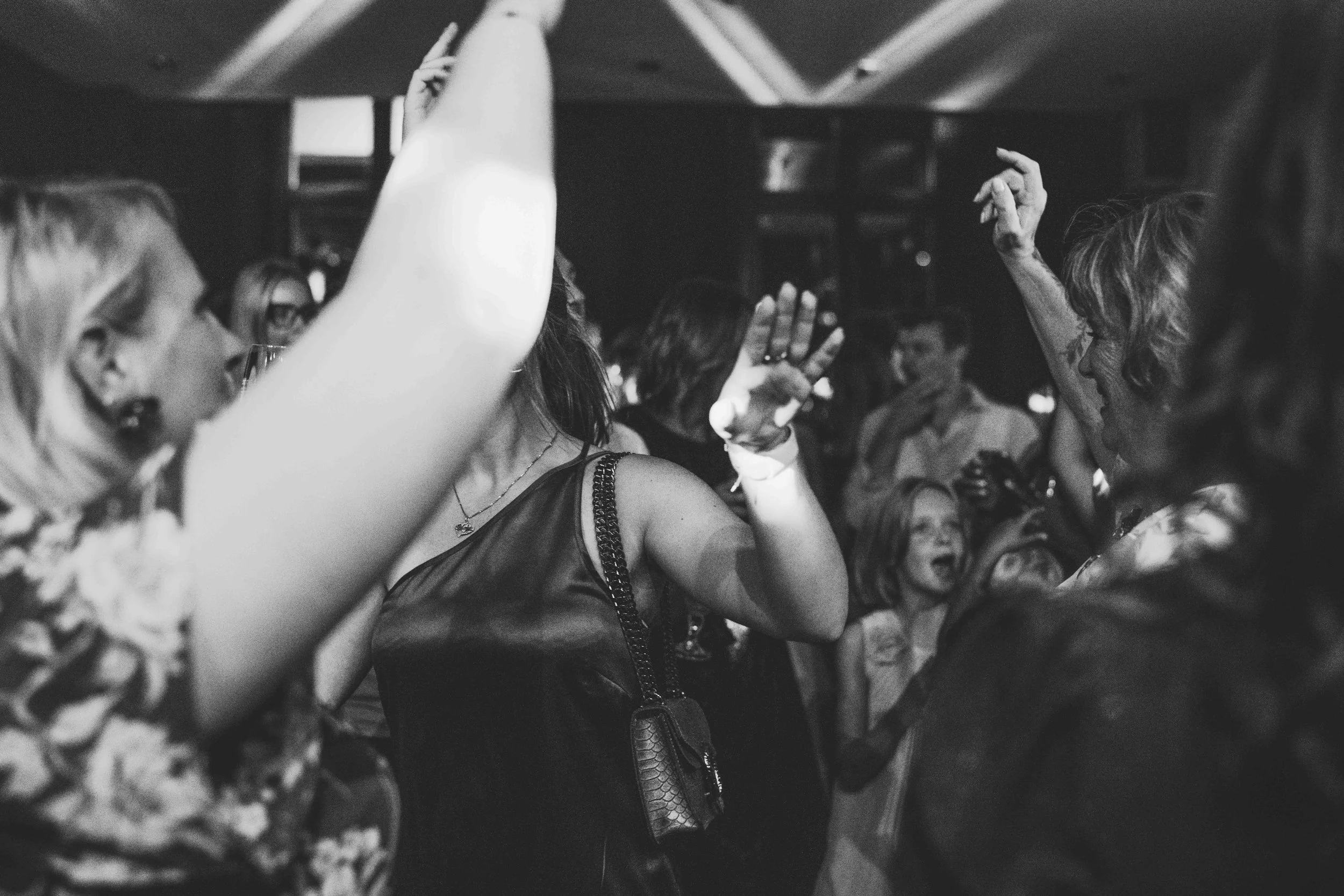 People dancing and celebrating at a party, black and white photo.