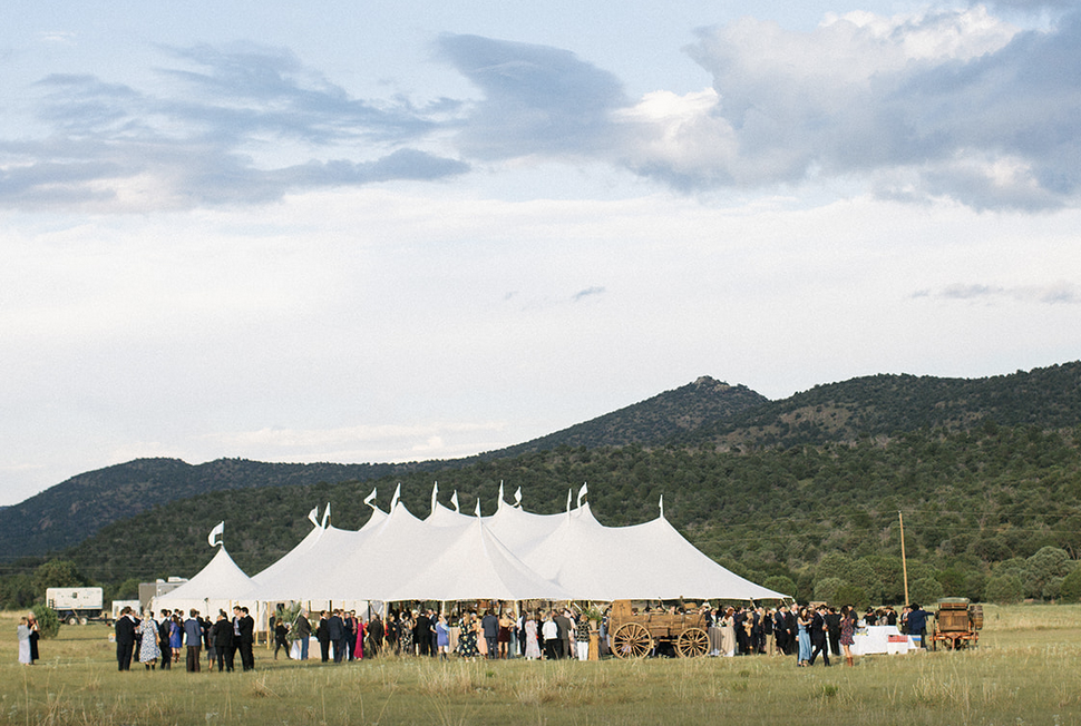 Wedding Tent sitting in a field with mountains in background