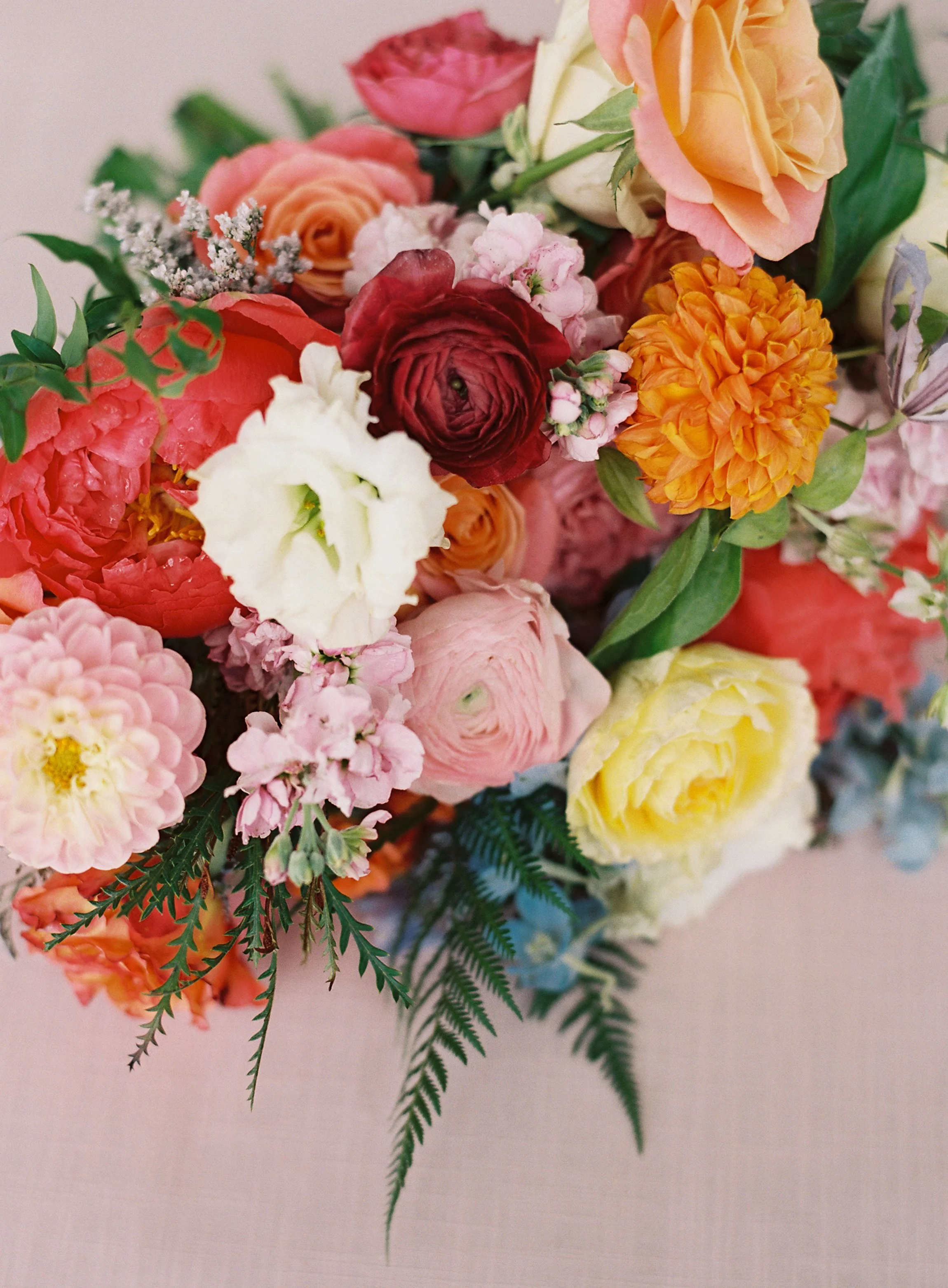 A colorful floral arrangement with bright pinks and corals