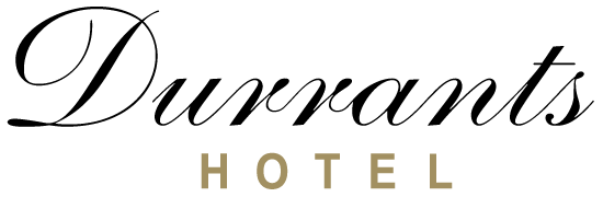 Text reading 'Durrants Hotel' in elegant script and block fonts on a black background.