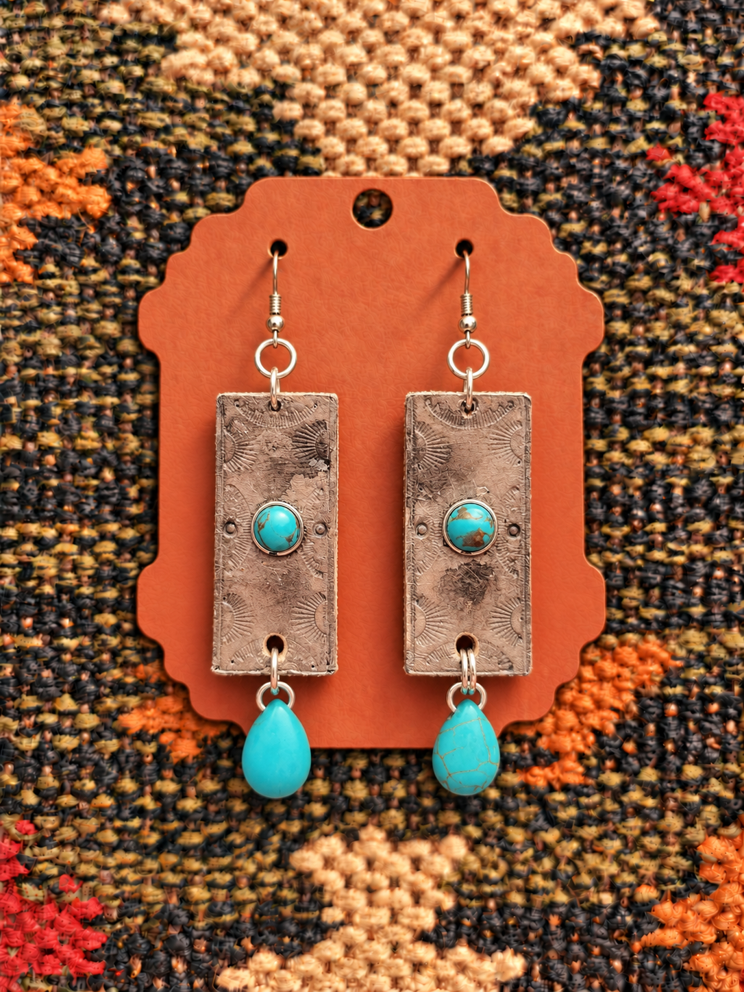Weathered turquoise dangle earrings on kilim.png